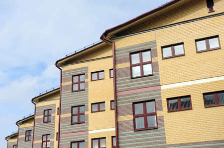 The house with plastic windows and a roof of corrugated sheet. Roofing of metal profile wavy shape...