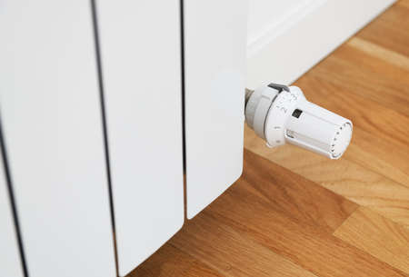 Thermostatic regulator on a radiator of water heating in the apartment.の写真素材