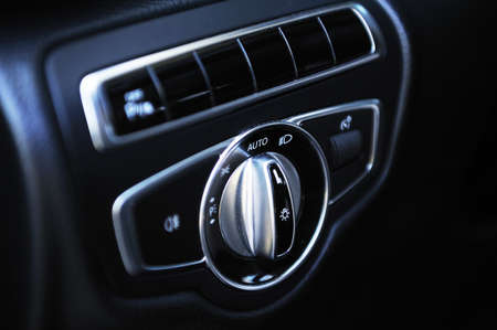 Close-up of car headlight adjustment dashboard