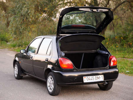 Belarus, Minsk-October 12, 2019: Ford Fiesta black 2000 year, parked in a parking lot in the forest, side view.のeditorial素材