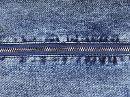 Zipper on blue jeans background. Close up of jeans texture.の写真素材