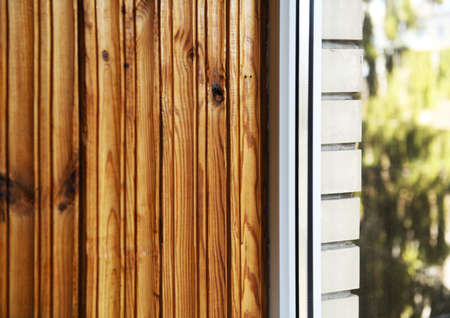 Close-up of a window in a wooden house. Wooden planks.