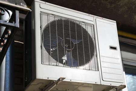 Air conditioner in factory, closeup view. Global warming concept