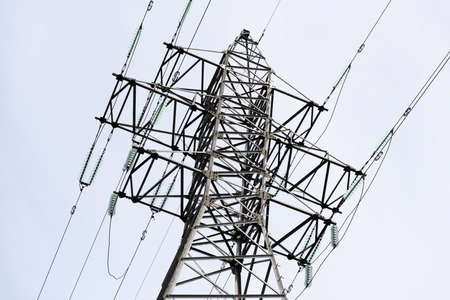 High-voltage pylons and wires against the blue sky.
