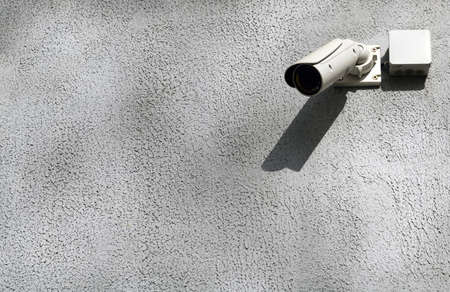 CCTV security camera or surveillance system on concrete wall with copy space