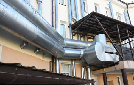 Pipes and ventilation systems on the roof of an apartment building.の写真素材