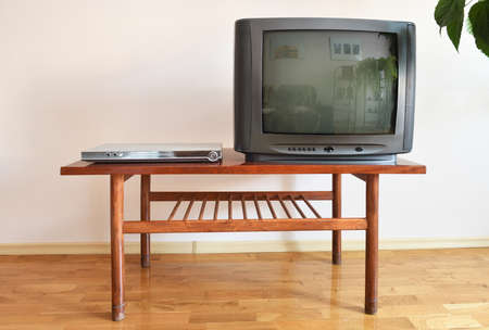 Vintage TV set on a wooden table in the living room.の写真素材