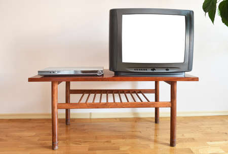TV on a wooden table in the living room with a green plantの写真素材
