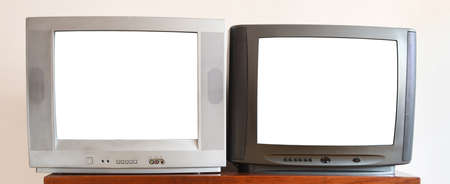 Two old TV sets with blank white screen on the wooden shelf.の写真素材