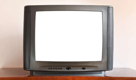 Retro television with white screen on a wooden shelf in the roomの写真素材