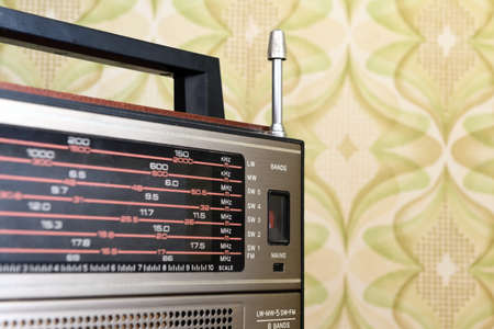 Retro radio receiver on the background of a vintage patterned wallの写真素材