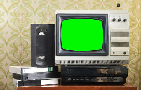 Old silver vintage TV with green screen to add new images to the screen, VCR on wallpaper background.の写真素材