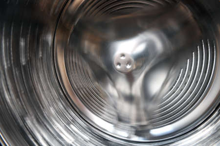 Close-up of a stainless steel drum for washing dishes. Shallow depth of field.