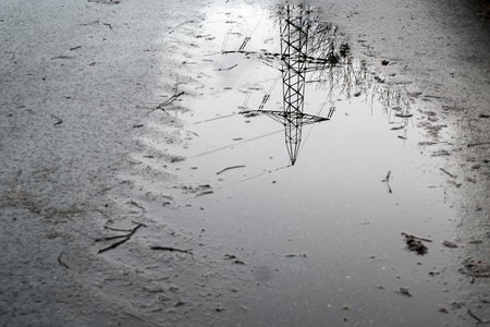 Reflection of a pylon in a puddleの写真素材