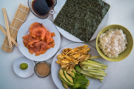 A number of ingredients on plates ready to make sushiの写真素材