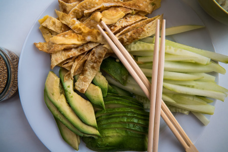 A number of ingredients on plates ready to make sushiの写真素材