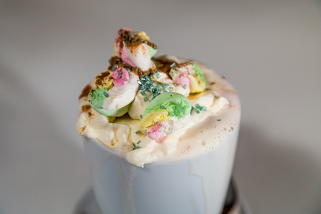 A tasty hot chocolate with lots of whipped cream and marshmallows.の写真素材