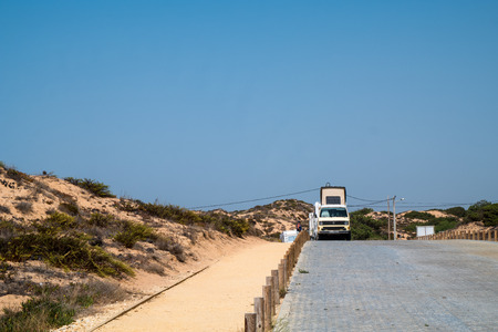 A vintage car on a road next to the beachのeditorial素材