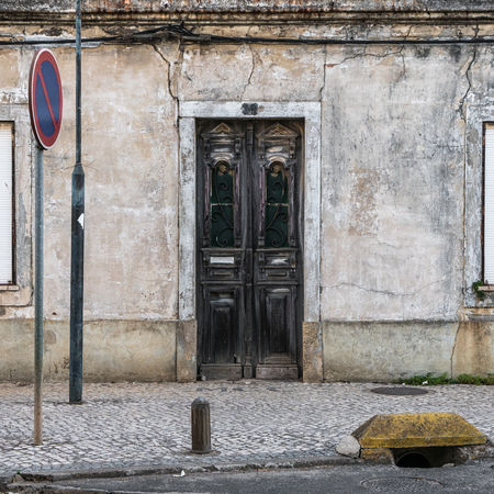 An old, broken and closed door in Portugalの写真素材