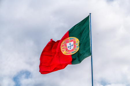 The portuguese flag blowing in the windの写真素材