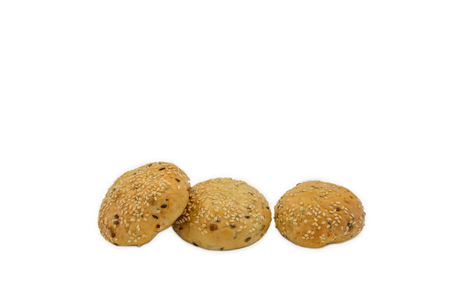 Rolls with sesame and raisin on white background, isolated, three piecesの写真素材