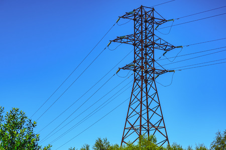 Power line towers against the background of the blue skyの写真素材