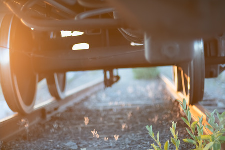 View under the train on wheels and rocky railwayの写真素材
