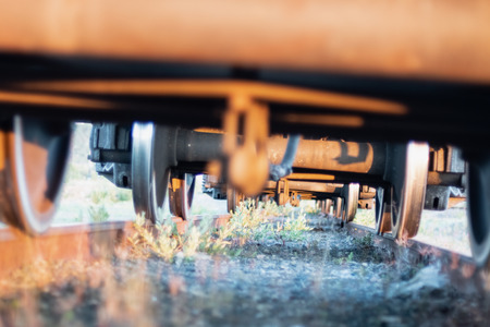 View under the train on wheels and rocky railwayの写真素材