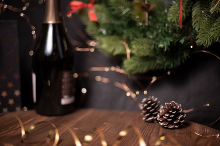 Smooth shady christmas and new year decoration background with wooden plate, round bokeh and pine coneの写真素材