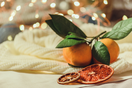 Winter and New Year's interior view with a lamp bokeh, garland of fires and tangerineの写真素材