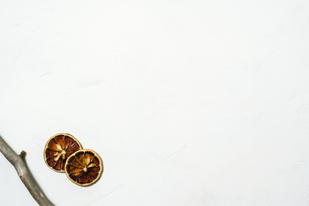 Two brown dryed orange small slice on a white marmor backgroundの写真素材