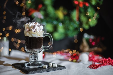 Smooth shady christmas and new year decoration background with round bokeh and cup of coffee with small marshmallowの写真素材