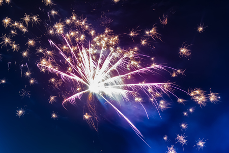 Bright festive fireworks against the background of the blue night skyの写真素材