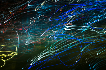 Bright abstract spiral patterns from light strips on a black backgroundの写真素材