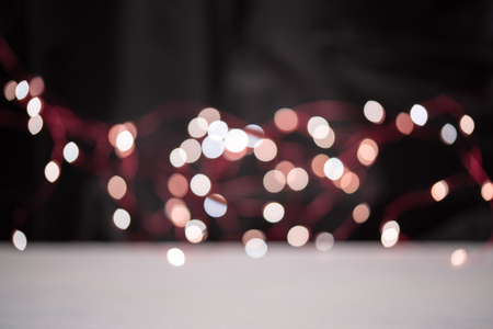Blsck background with bright garland bokehの写真素材