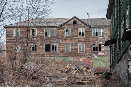 Old destroyed abandoned dirty raw wooden house with the broken out windowsの写真素材