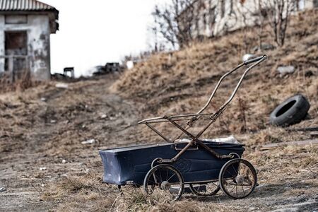 Blue baby carriage against the background of the abandoned apocalypse dirty areaの写真素材
