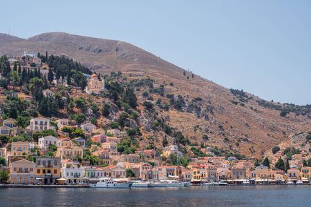 View of the coast of Symi island with multicolored houses in summer day, Greece, Europeのeditorial素材