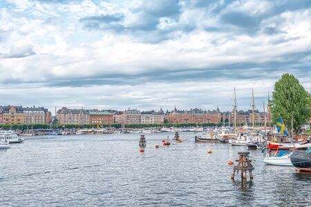 STOCKHOLM/SWEDEN - AUGUST 2, 2019: View on coastline of Skeppsholmen island with boats and shipsのeditorial素材