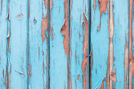 Old fence with the blue peeled-off paint and nailsの写真素材