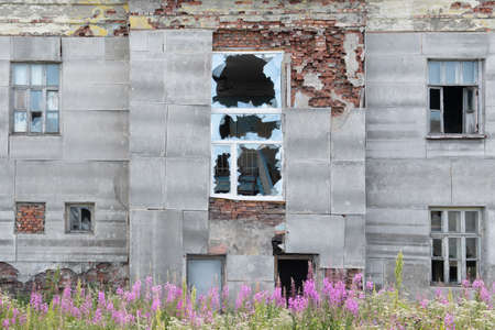 Old destroyed abandoned dirty raw wooden building of hospital with the broken out windowsの写真素材