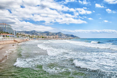 Sitges, Spain - 28 April 2018: View on the old town from the beach with peopleのeditorial素材