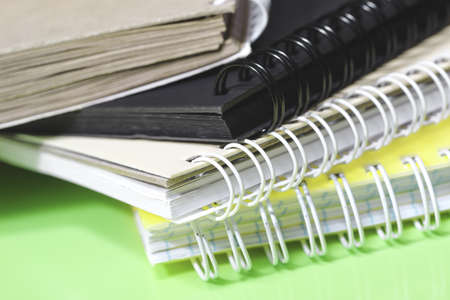 Stack of colorful notebooks with spiral edge, school or educational background