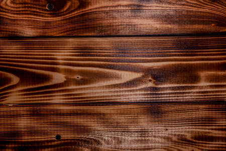 Old grungy burning wood surface texture. Rustic old reclaimed wood backgroundの写真素材