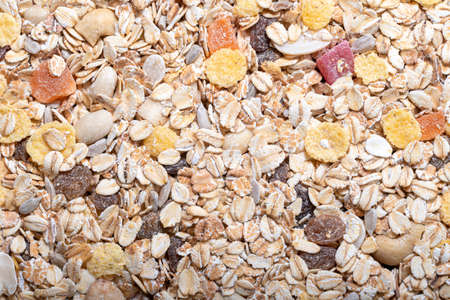 Organic muesli cereal with oats and nuts. Texture oatmeal muesli as background. Top view or flatlay. Copy space for text.の写真素材