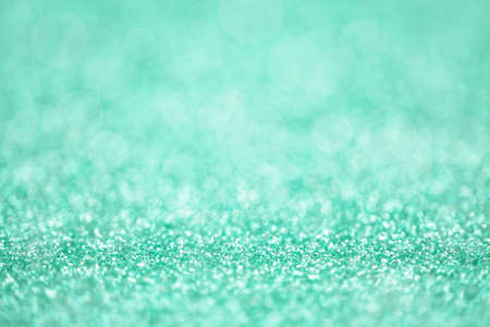 Texture of mint green silver glitter dust surface, luxury background with bokehの写真素材