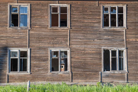 Old destroyed abandoned dirty raw wooden building with the broken out windowsの写真素材