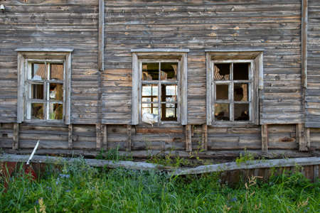 Old destroyed abandoned dirty raw wooden building with the broken out windowsの写真素材