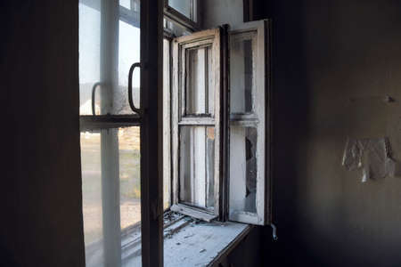 Old grunge broken out window in destroyed abandoned houseの写真素材
