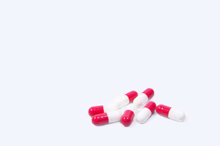 Red and white medical pills isolated on white backgroundの写真素材